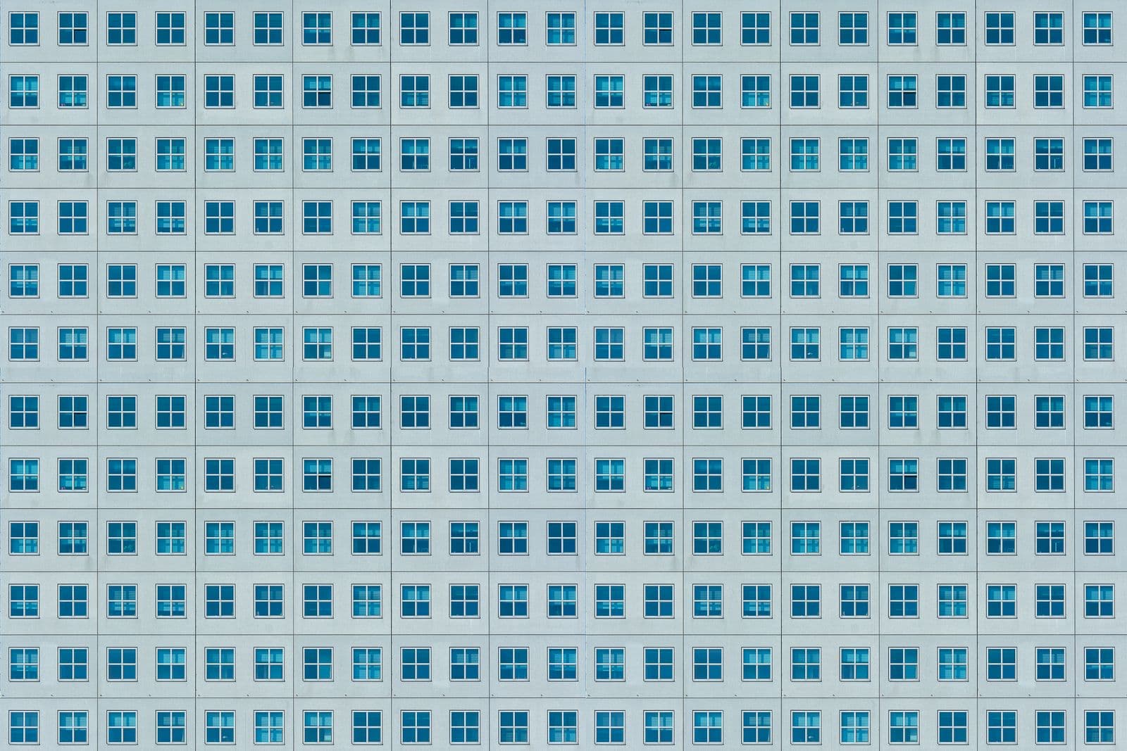 A regular grid of windows across a building facade